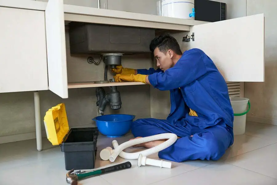 plumber cleaning drain