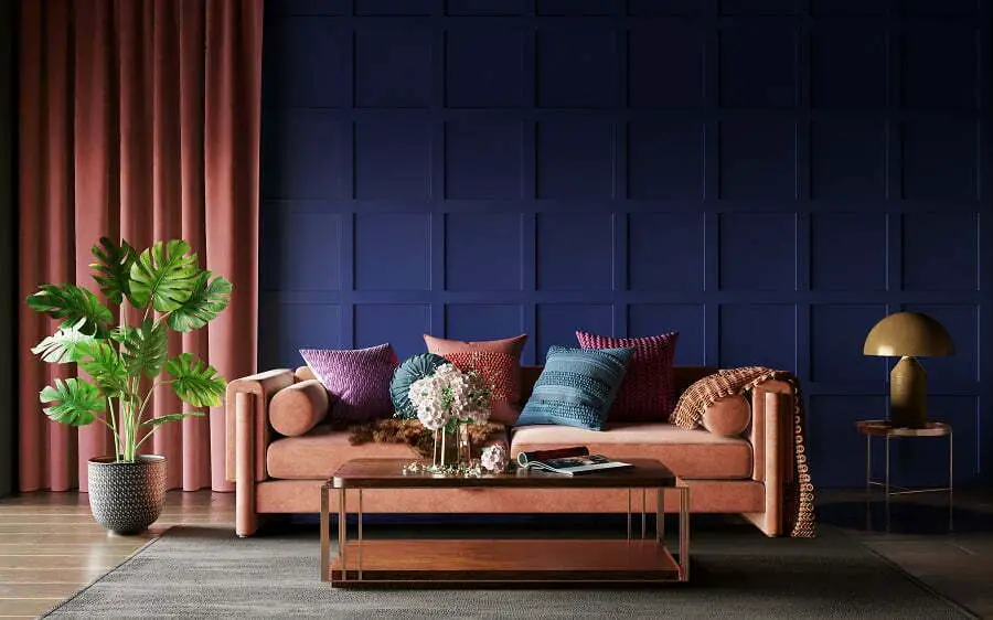 sofa with accent -pillows against dark blue wall