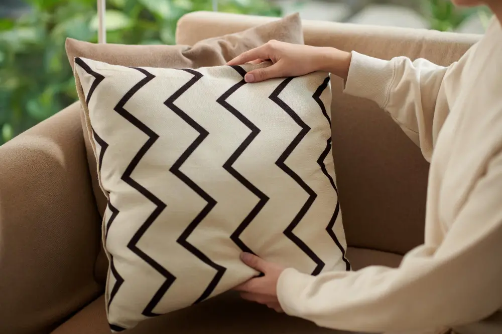 woman putting cover of cushion