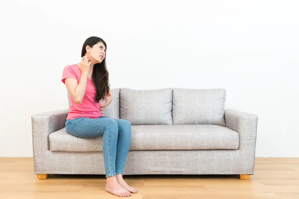 woman scratching in couch