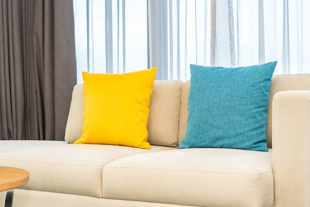 beige couch with colorful pillows
