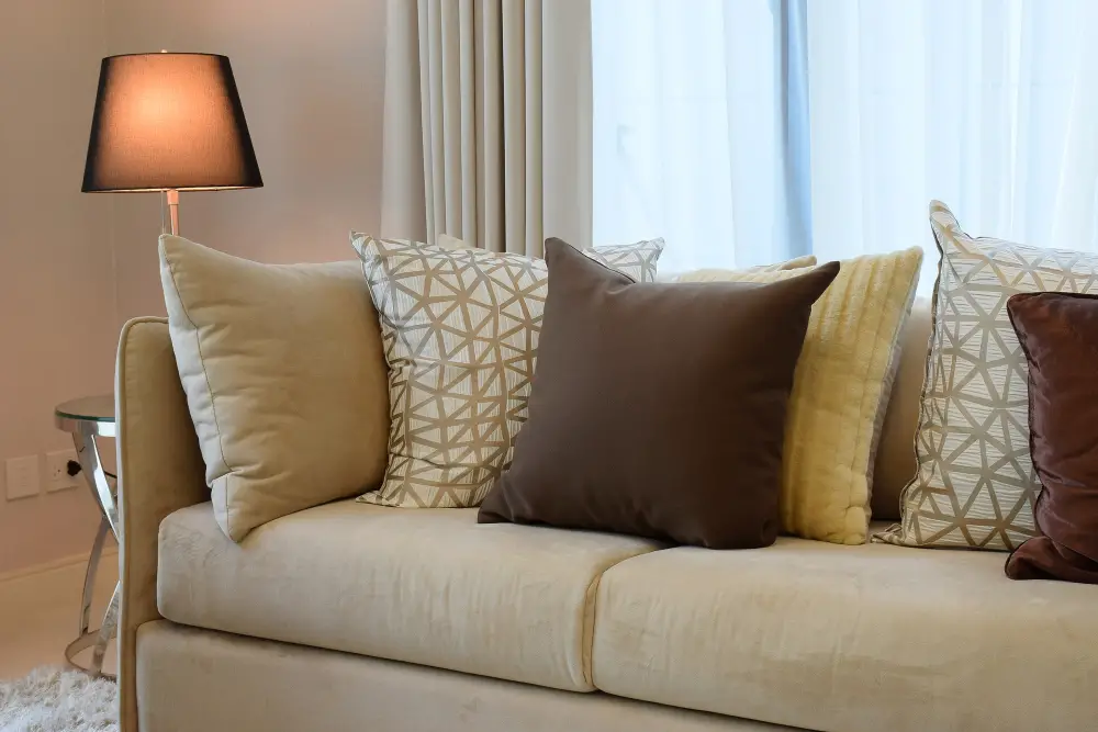 beige couch with printed pillows