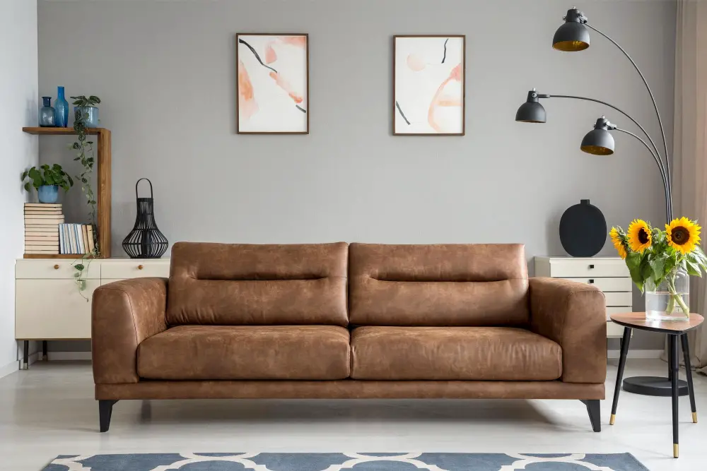 brown leather couch gray wall