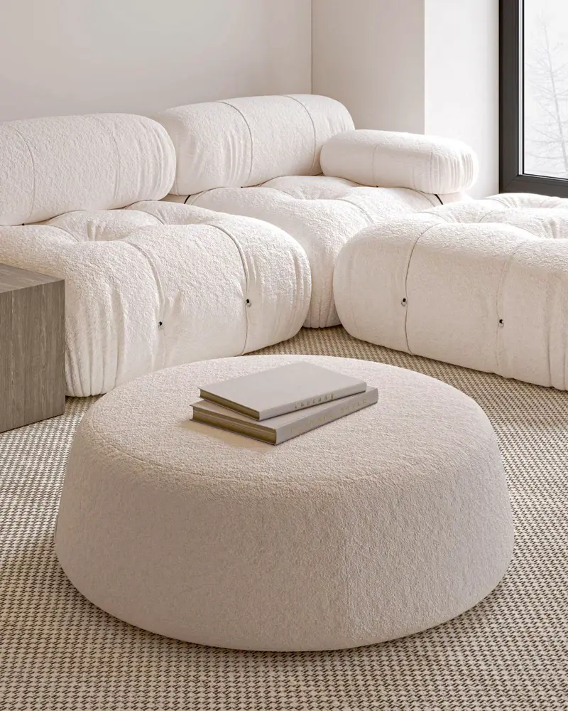 white couch and a round ottoman
